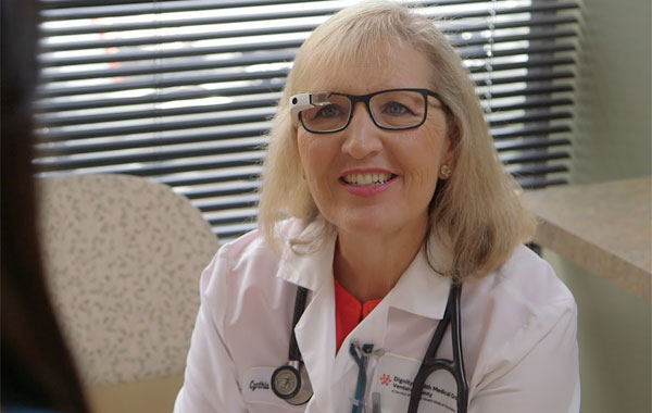 A medical doctor wears Google Glass during a patient consultation.