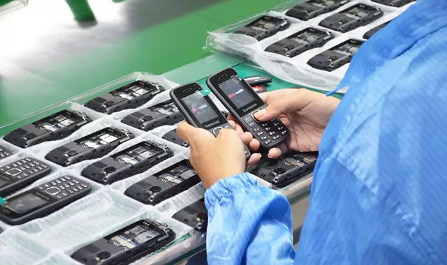 A worker inspects the Starmobile phones assembled in the company's facility.