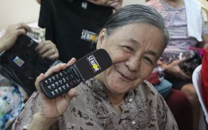 Lola Dominga shows the Cloudfone Lite Senior Flip she received during Cloudfone's CSR Give-Back Project.