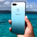 The OPPO F9 Jade Green matches the background.