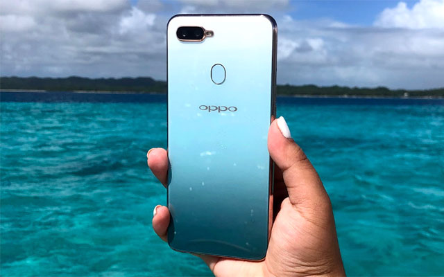 The OPPO F9 Jade Green matches the background.
