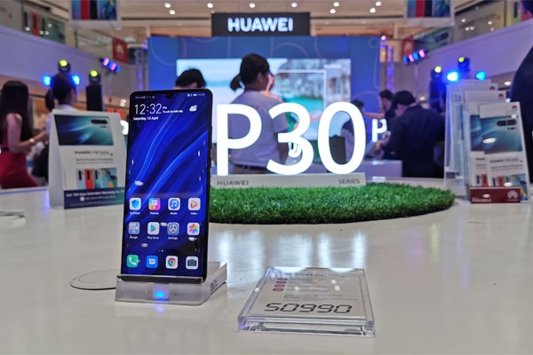 A Huawei P30 Pro smartphone displayed at the event.