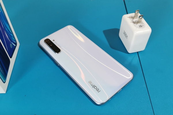 The Realme XT and its VOOC charger.