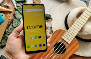 Realme smartphone with Realme wallpaper.
