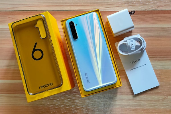 The realme 6 and its accessories inside the box.