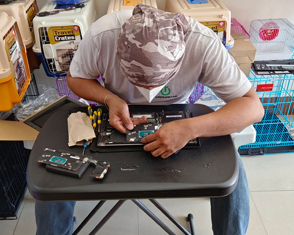 A Lenovo service partner technician replaces the laptop’s motherboard and SSD in our petshop.