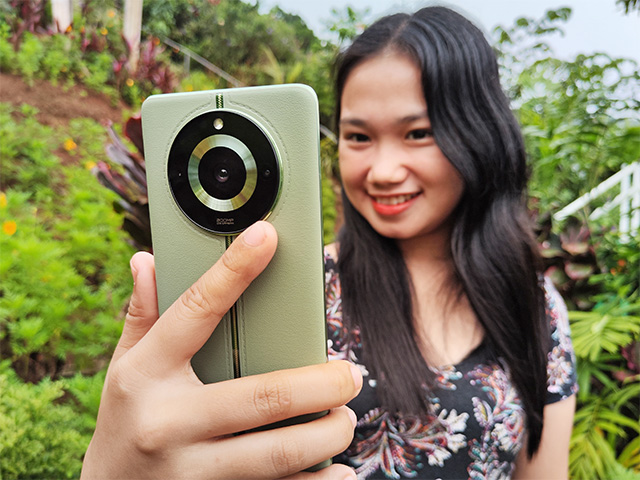 Taking a selfie with the realme 11 Pro+ 5G smartphone.